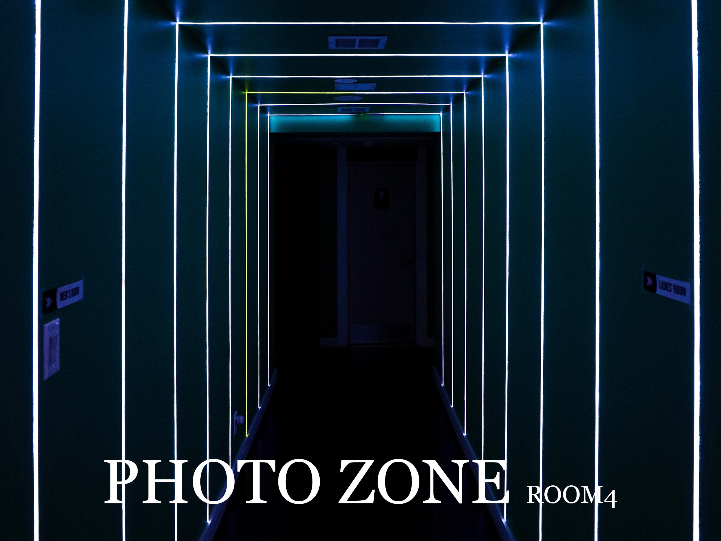 Woobi photo zone hallway outlined with blue neon lights